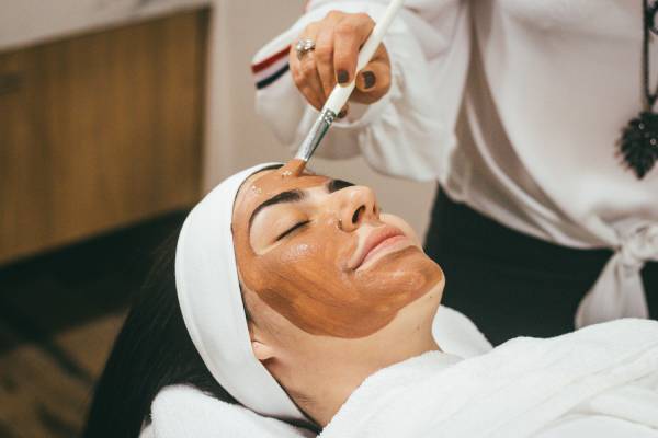 a woman having a facial skin care