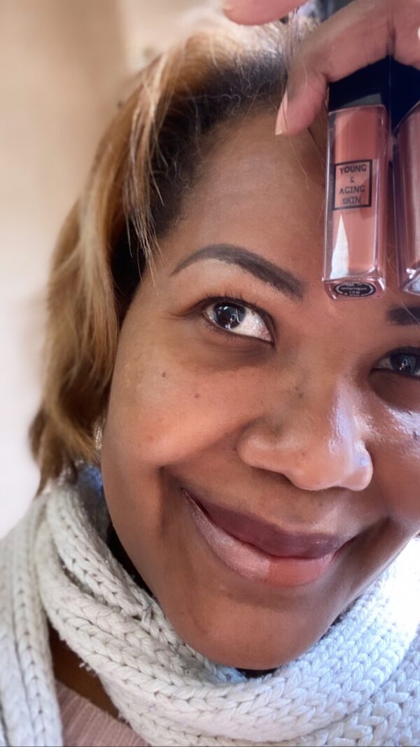 A person holding two liquid makeup containers