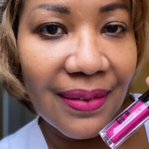 A person wearing a pink liquid lipstick