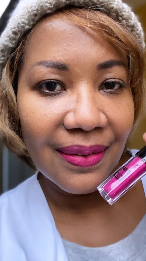 A person wearing a pink liquid lipstick